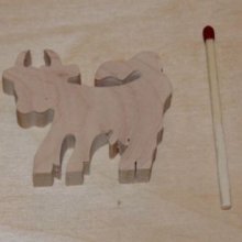 Miniature wooden cow figurine to decorate